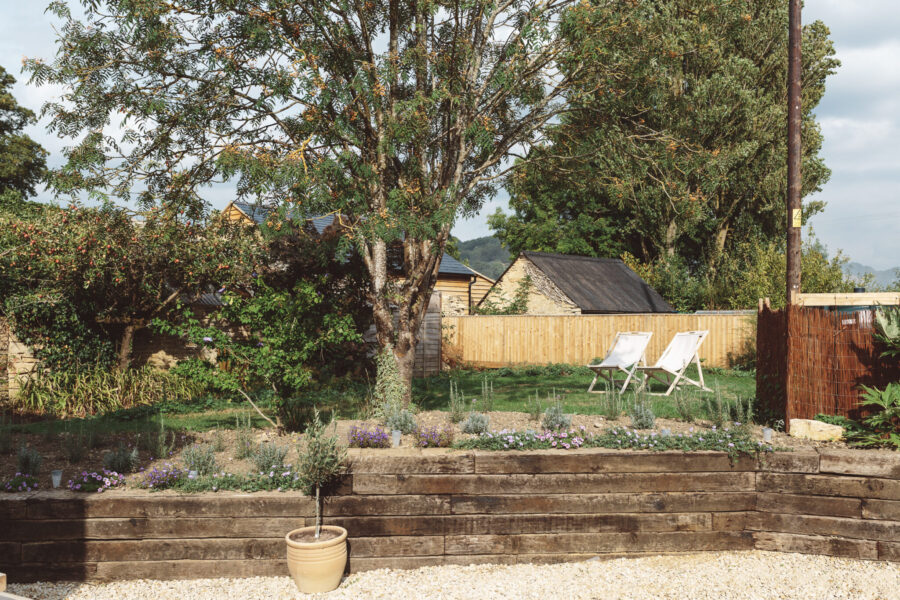 Summery cottage garden with chairs