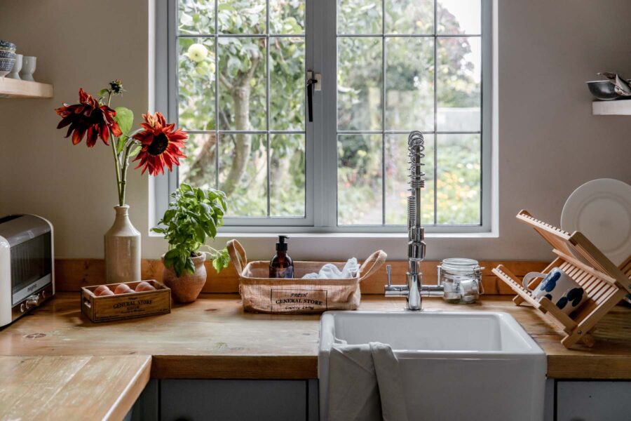 Cottage kitchen windowsill with flowers and toiletries