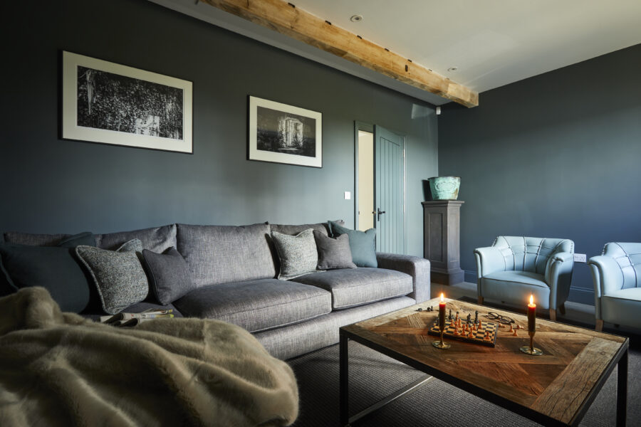 Cosy sofa corner with candles and games on coffee table