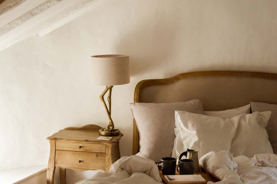 Cosy cottage master bedroom with cups of tea