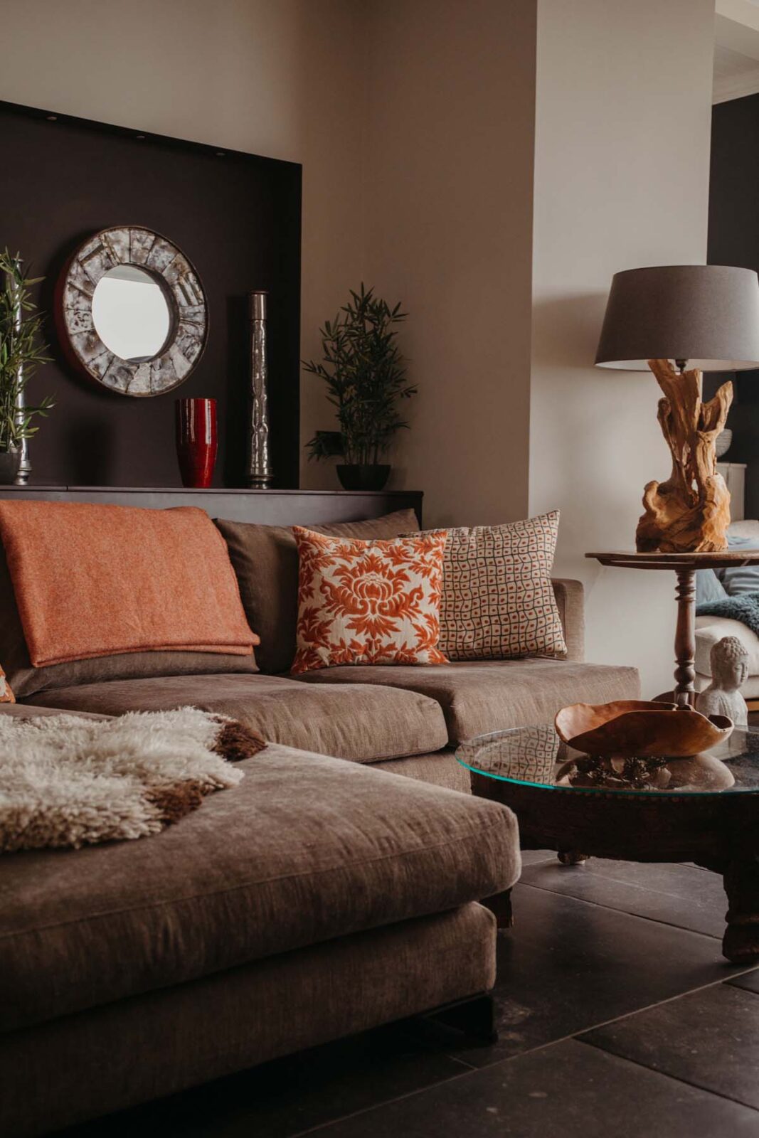 Cosy living room with warm furnishings and a driftwood lamp