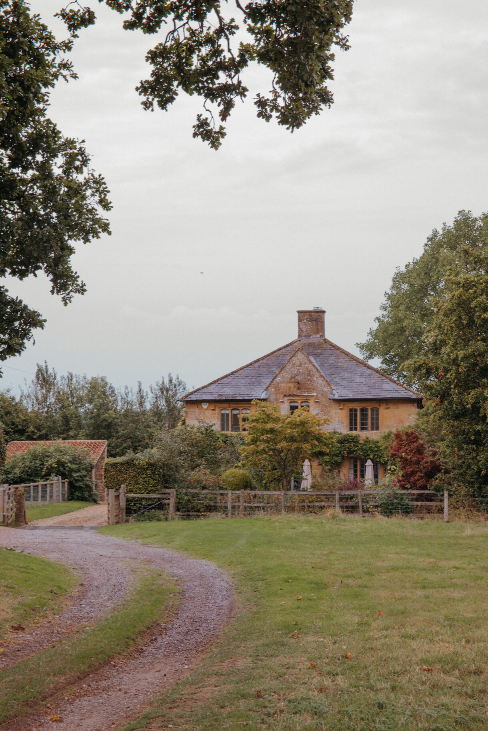 A winding pathway leading to a pretty country house