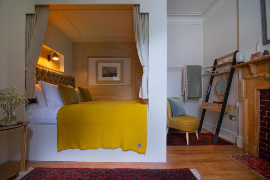 Yellow bedroom with four poster bed