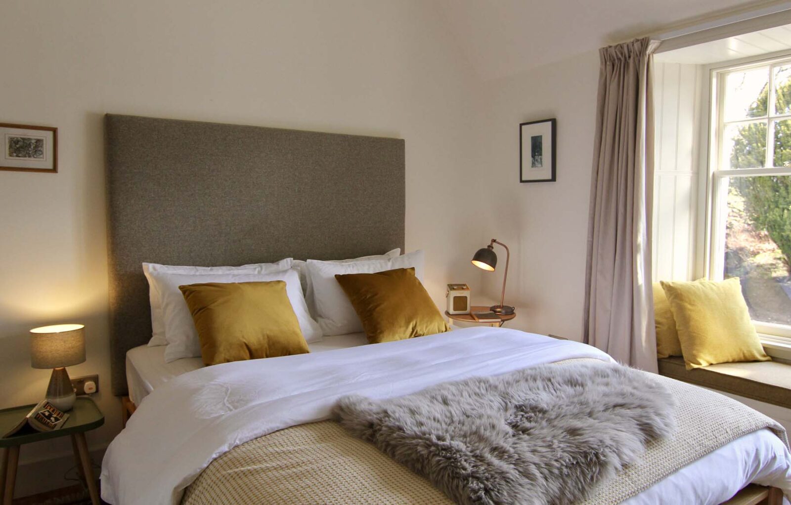 King size bedroom with yellow velvet cushions