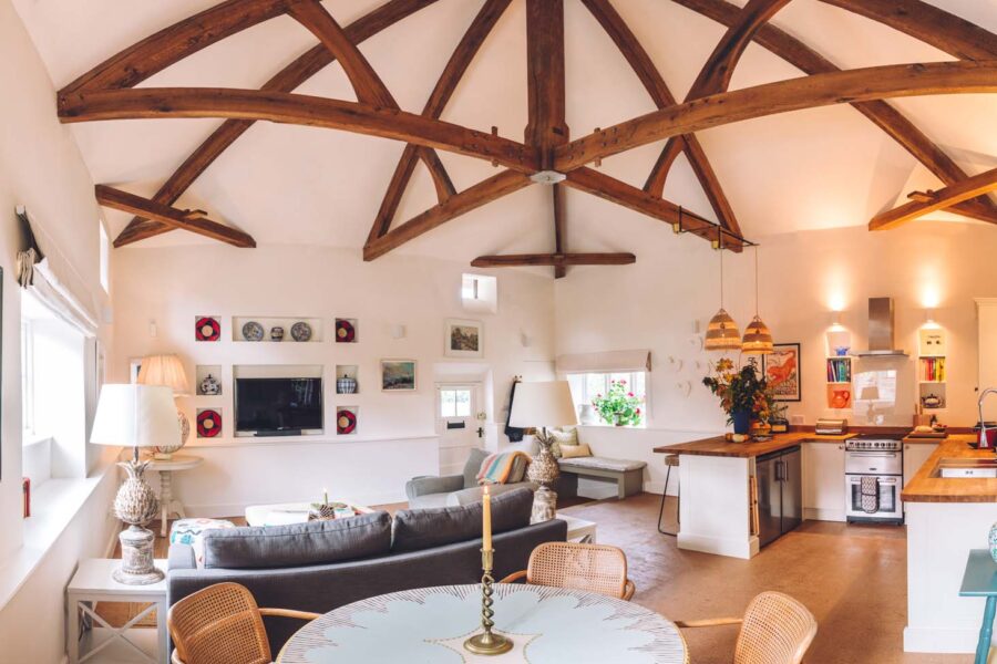 Open plan living room with high wooden beams