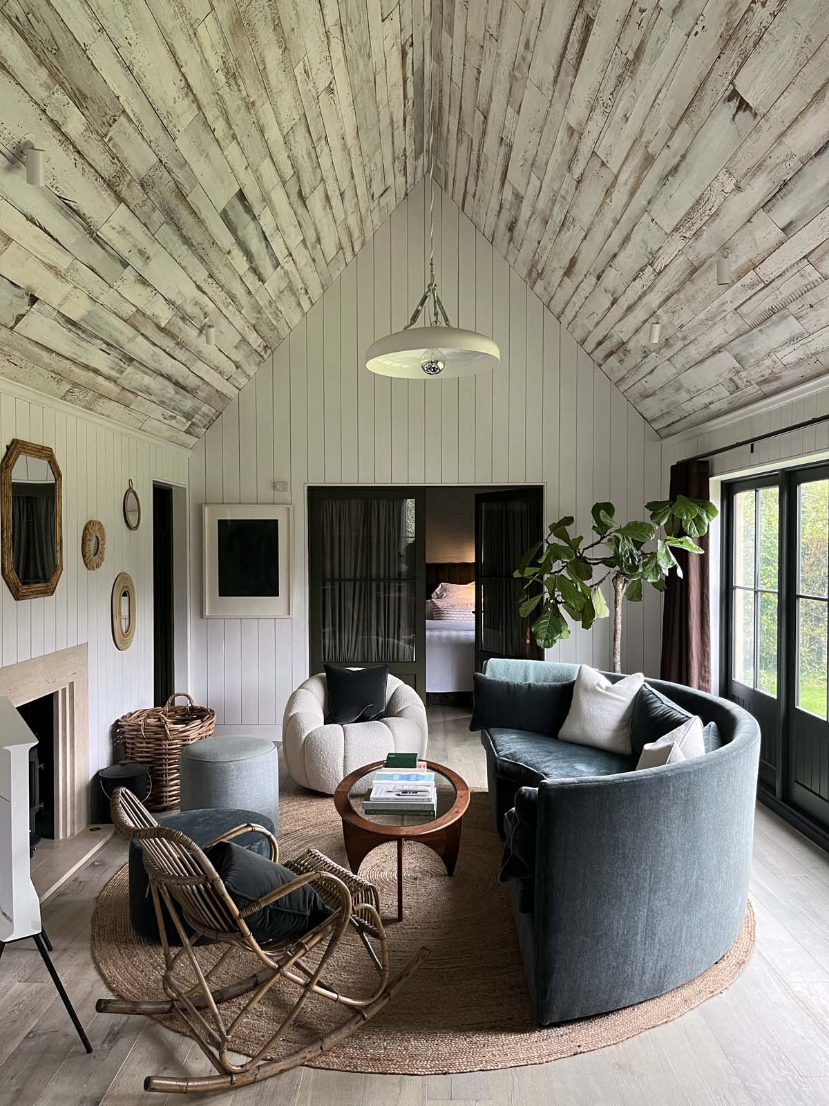 Living area with wooden vaulted ceiling and hanging pendant light
