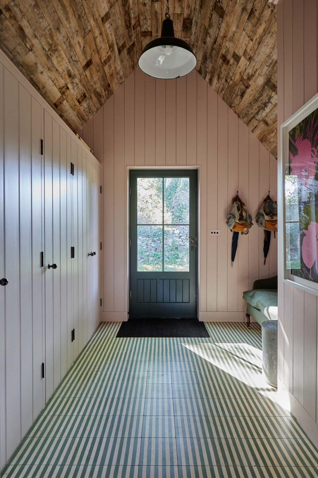 Entrance hall with striped floor and coat hangers