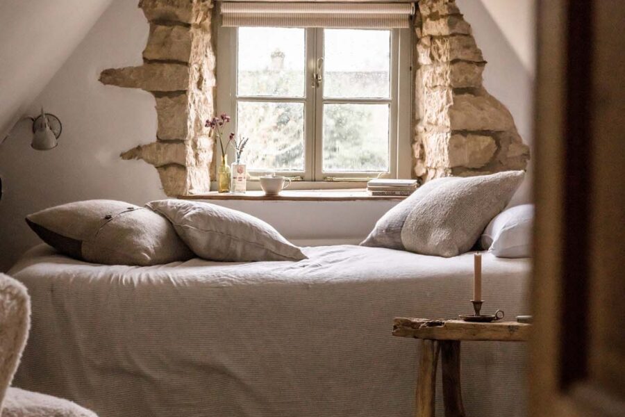 bedroom in eaves with window behind bed