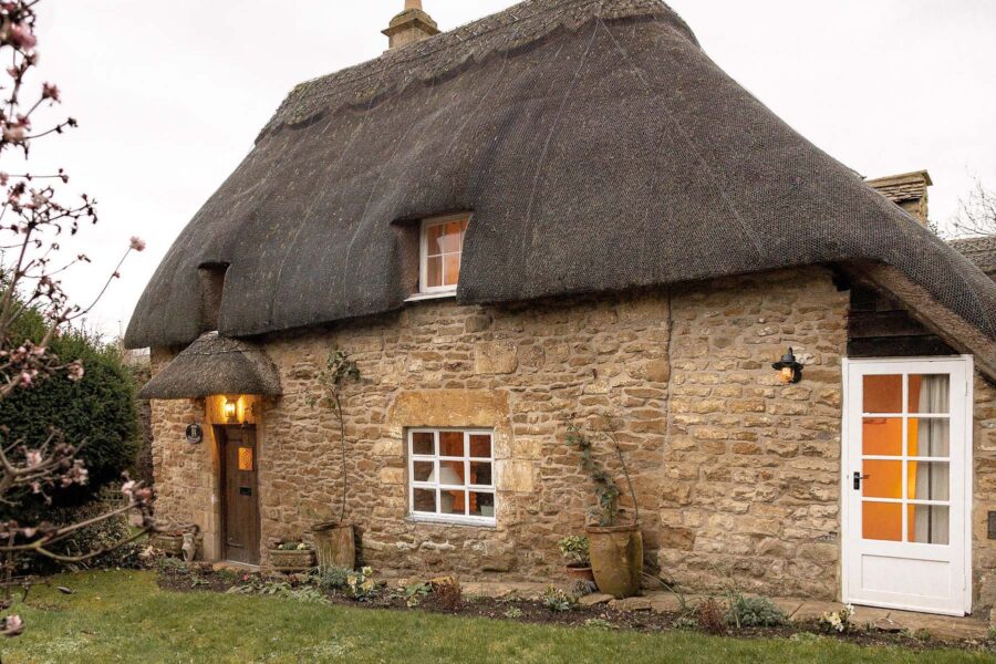 Thatched cottage with honey coloured stone