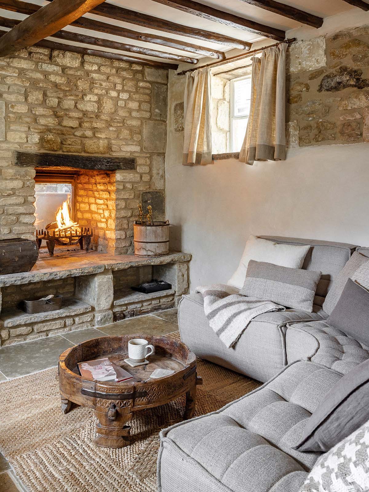 Modern grey corner sofa in a cosy cottage living room