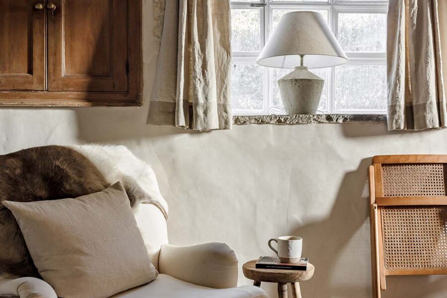 Modern white armchair in a rustic cottage
