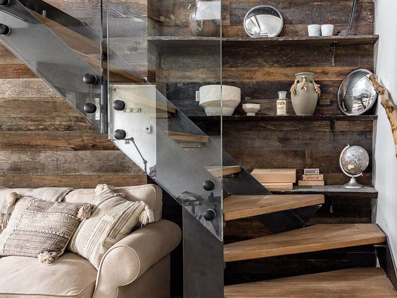 Staircase with wooden floating steps and a glass bannister