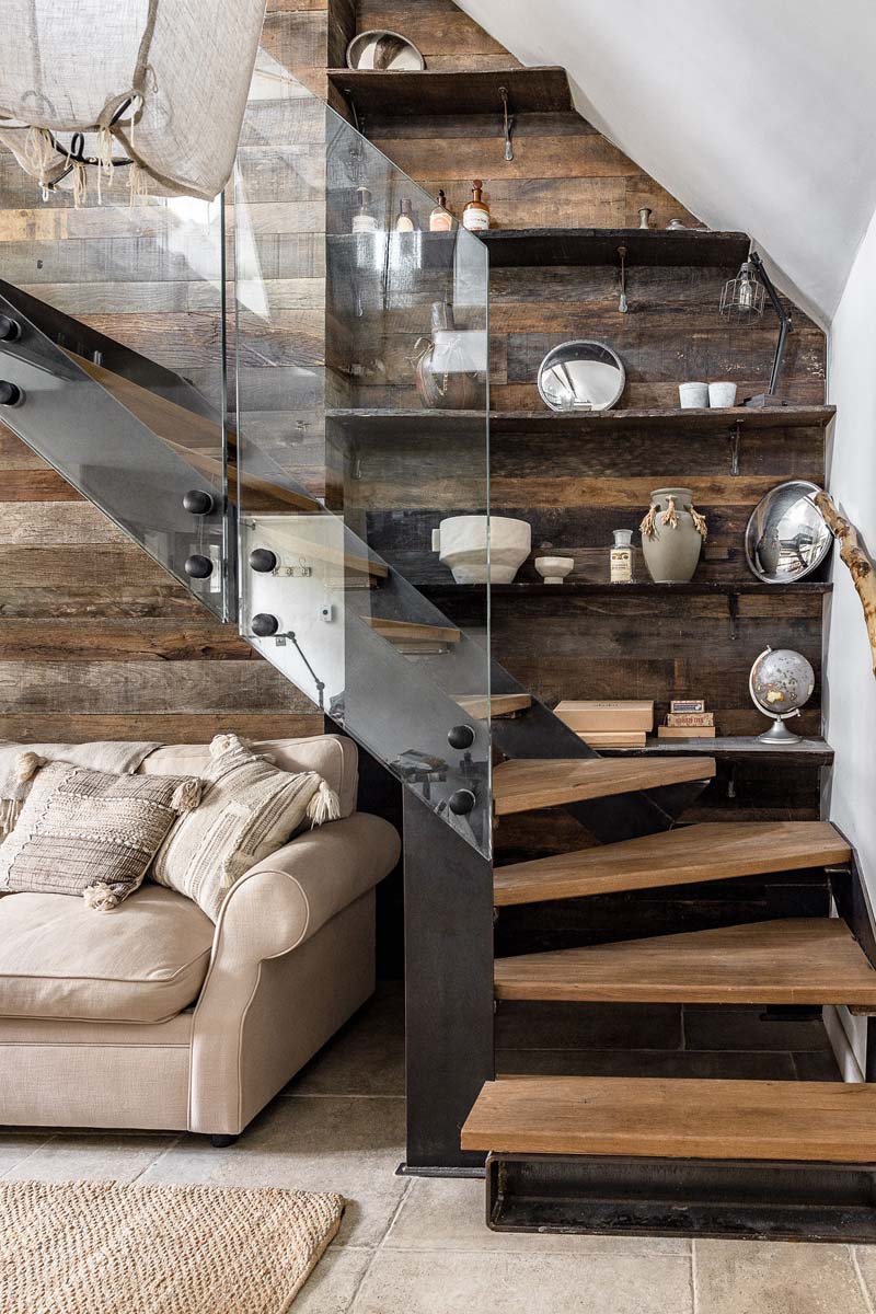 Staircase with wooden floating steps and a glass bannister