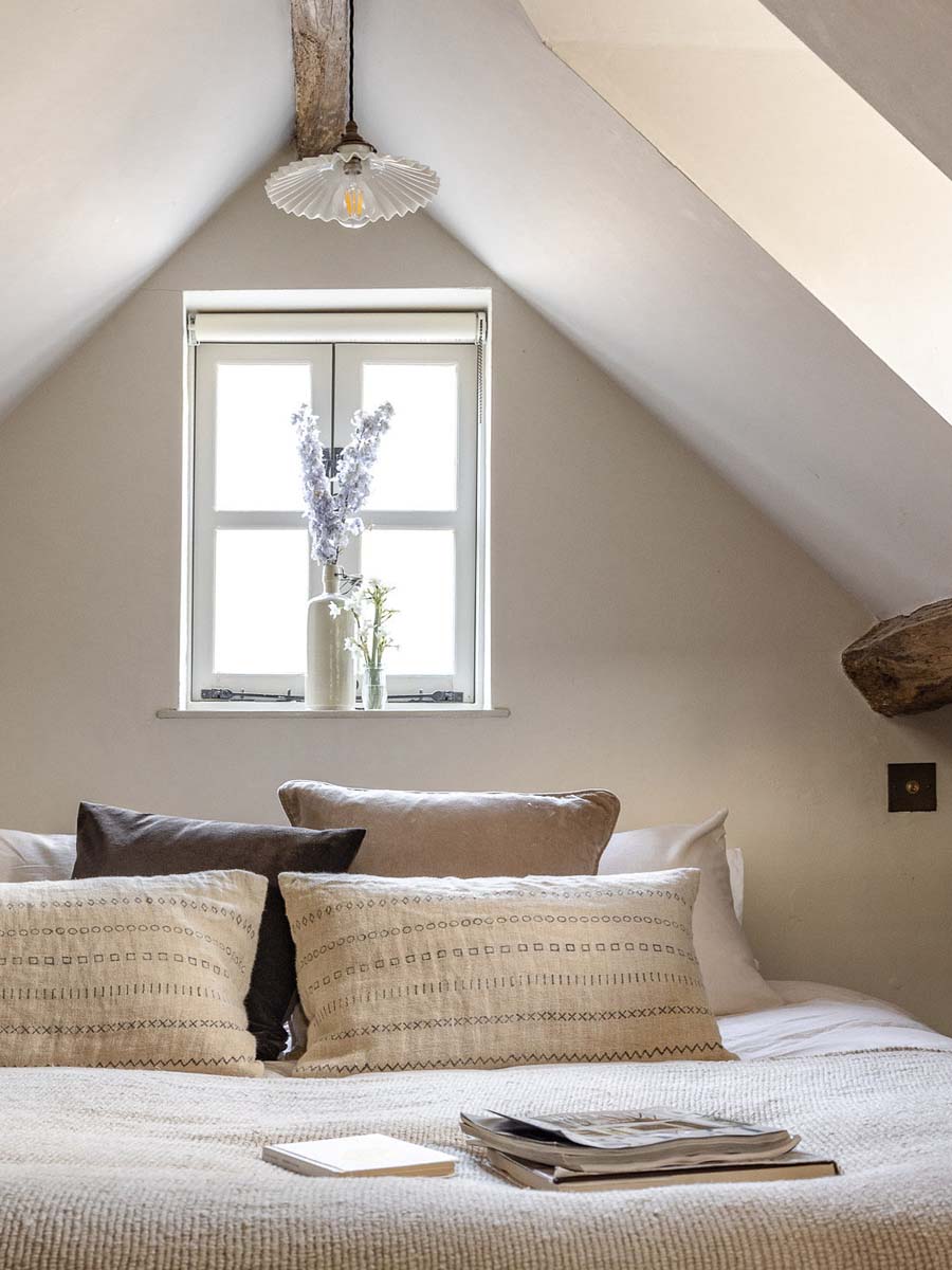 Eaves bedroom with neutral linen bedding