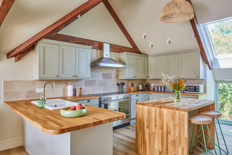 kitchen with sage green cabinets and central island